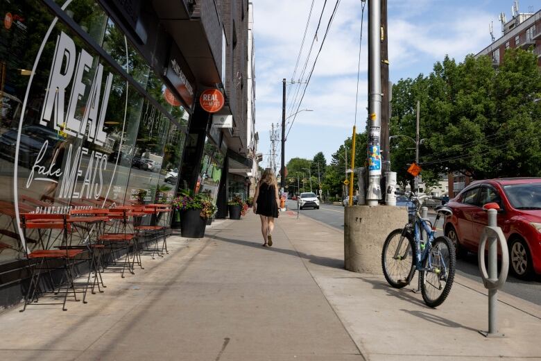 A woman walks along a Halifax sidewalk. 