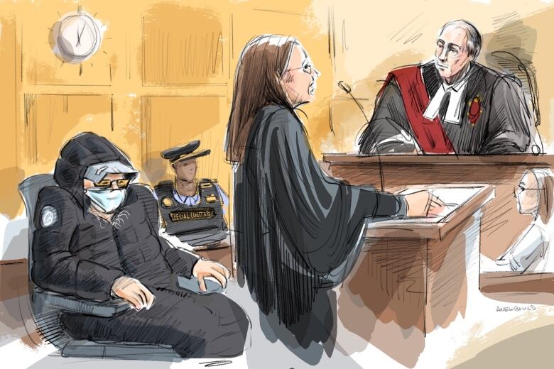 A man in a black parka with a face mask on sits behind a lawyer. A judge sits before them.