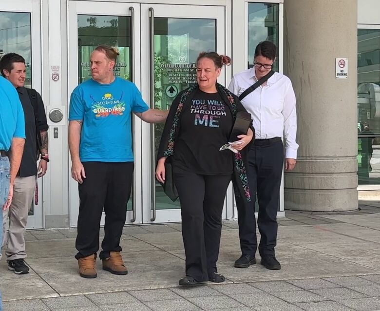 A group of people on courthouse steps.