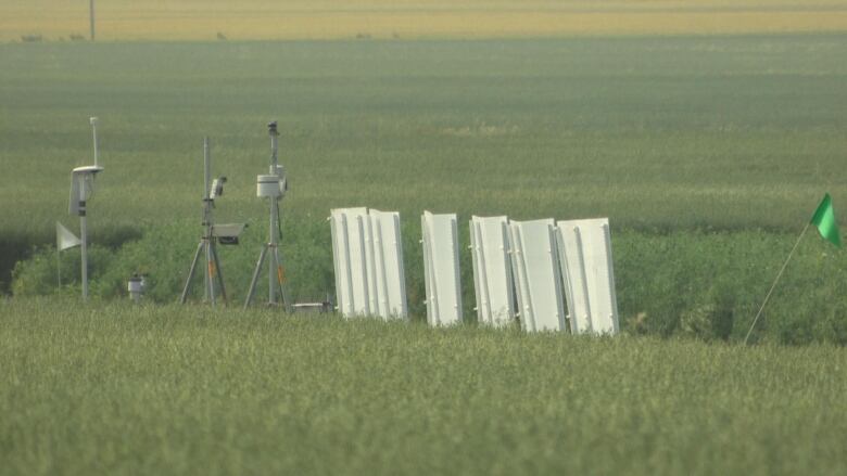 Equipment is visible in a field.