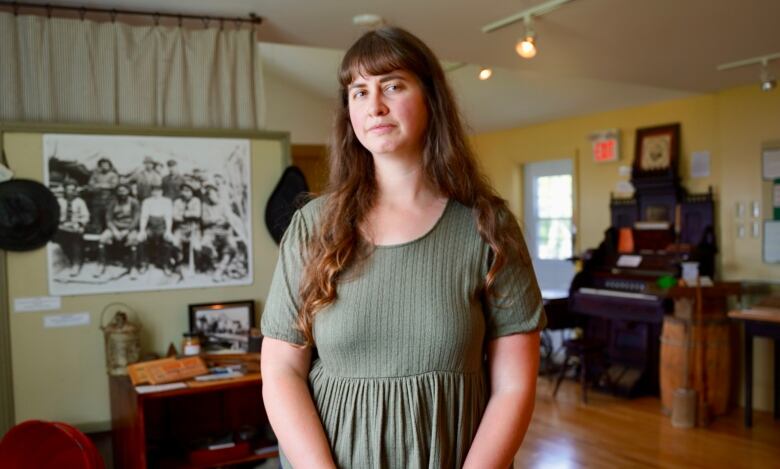 Woman stands in front of microphone.