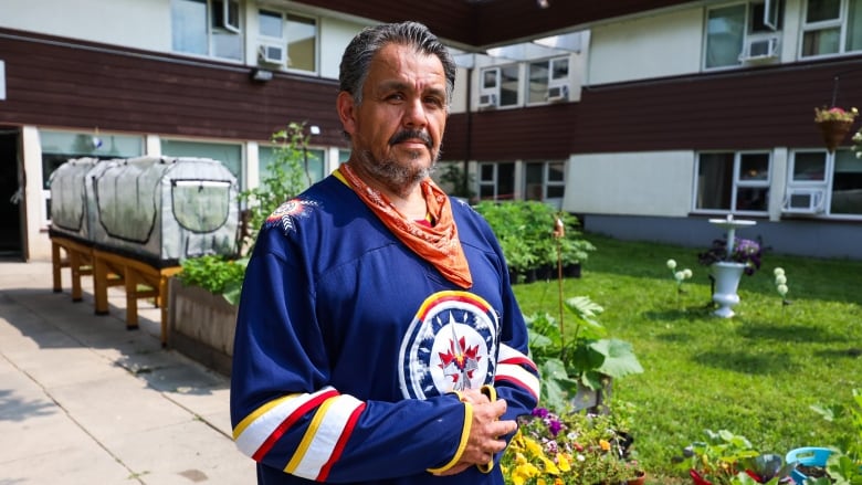 A man wearing a jersey poses for the camera