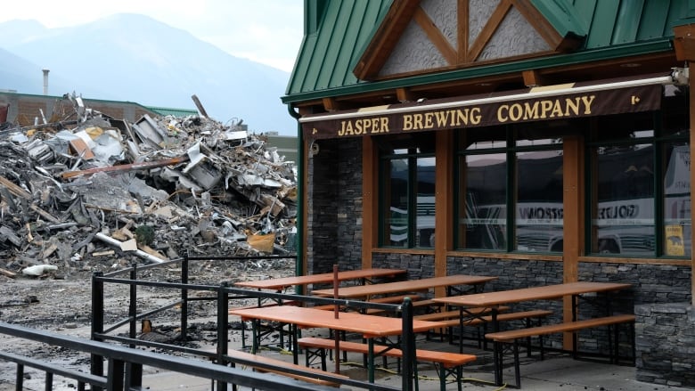 A building next to a pile of rubble.