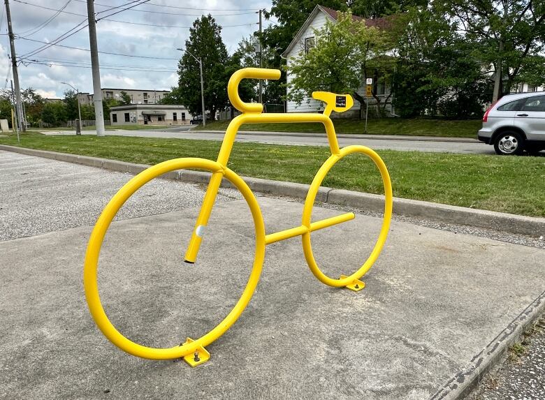 A bicycle-shaped bike rack.