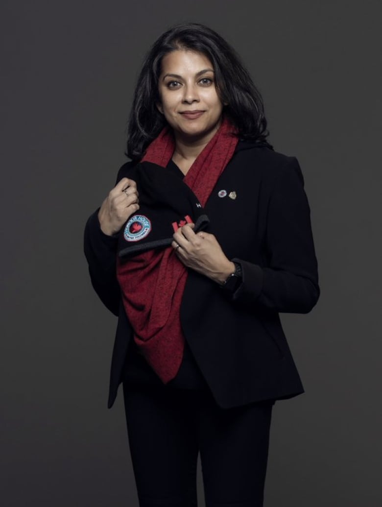 A woman with dark hair poses for the camera.