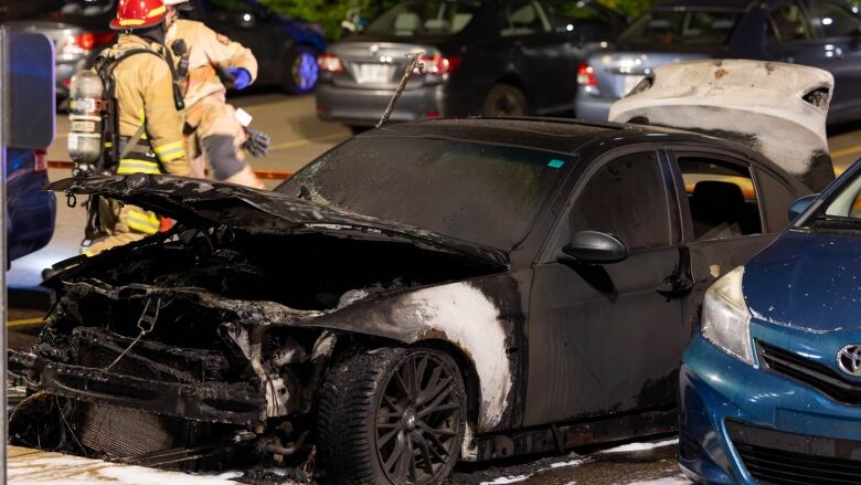 a scorched car in a parking lot