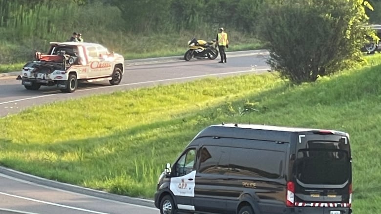 Police and a tow truck at the scene of a fatal motorcycle crash in Toronto.