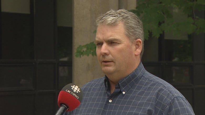 Minister of Agriculture, Bloyce Thompson, speaking in front of a building.