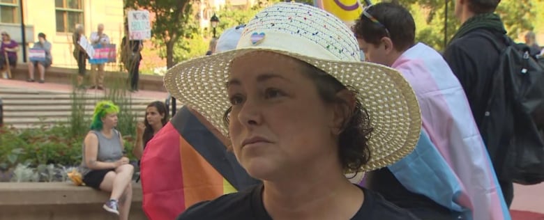 A close-up shot of a woman in a hat. 