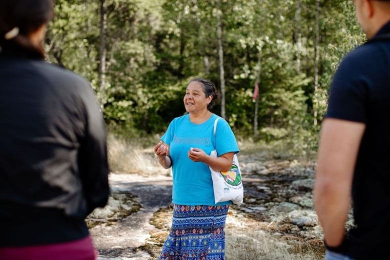 A woman talks to a group. 