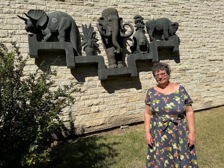 Senator Paula Simons stands in front of the museum building. 