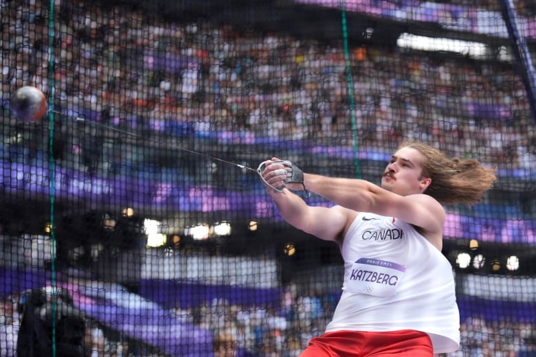 A men's hammer thrower is seen competing.