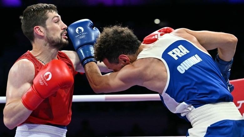 Two male boxers exchange left punches.