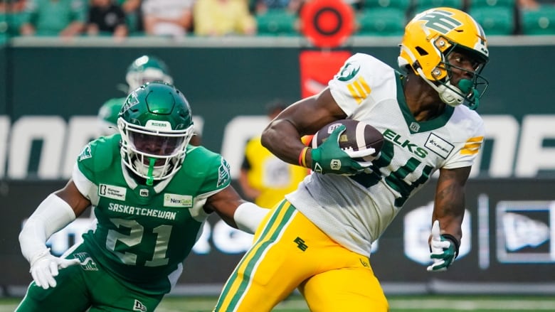 roughrider player is chasing elk player on the football field