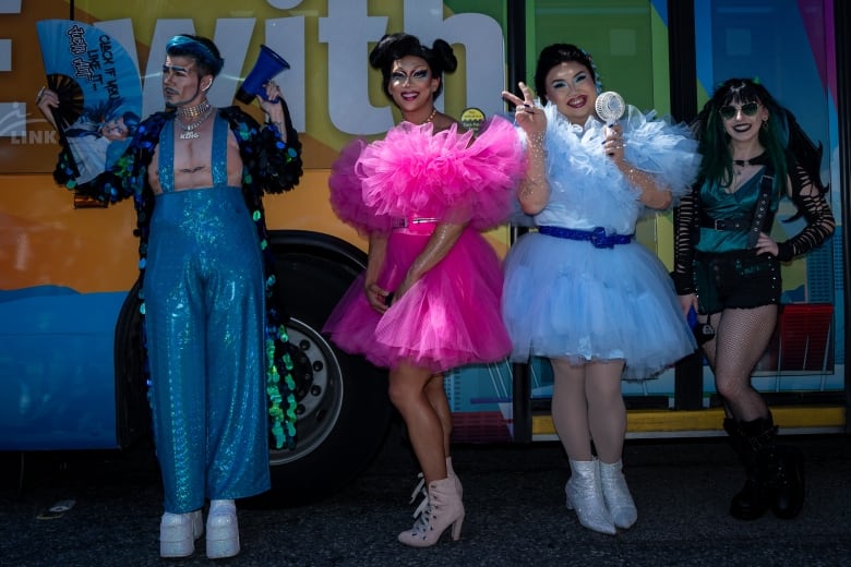 People dressed up pose for a photo before the Pride Parade in Vancouver