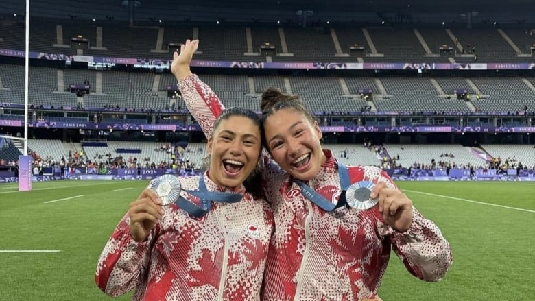 Teammates win silver medal, wearing their team Canada gear. 