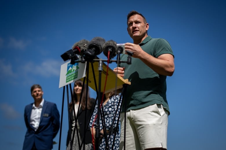 A white man speaks at a podium marked 'Vancouver Board of Parks and Recreation'.