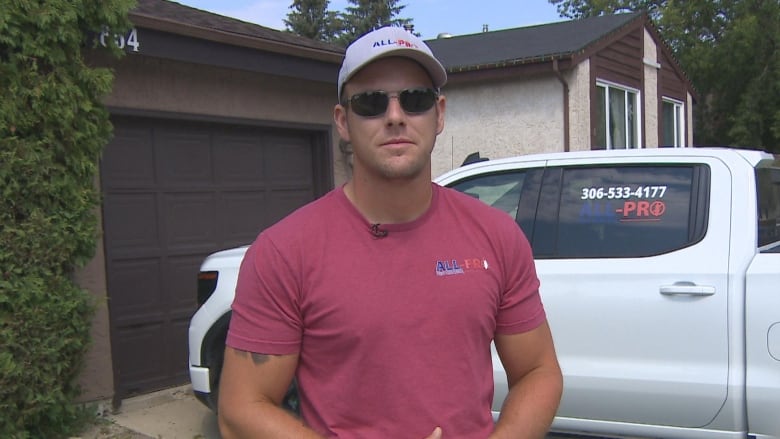 A man standing in front of a truck