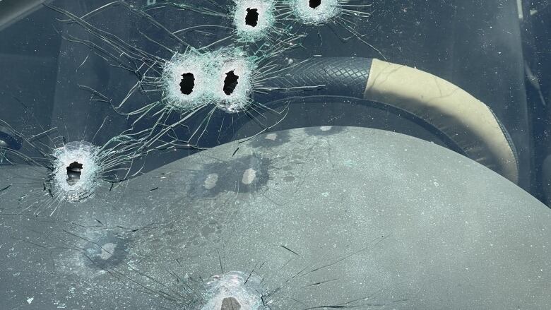 gunshots in the window of a car