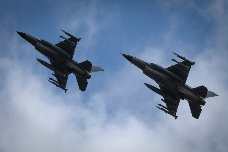 F-16 fighter jets, recently delivered to Ukraine, are seen flying at an undisclosed location in the country on Sunday.