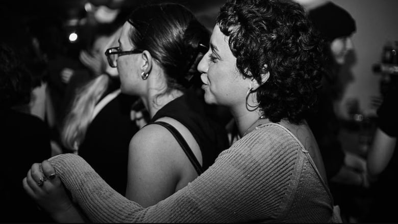 black and white photo of two women dancing together