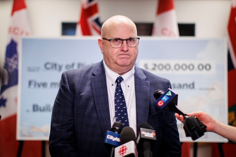 Photo of a man in a suit during a news conference