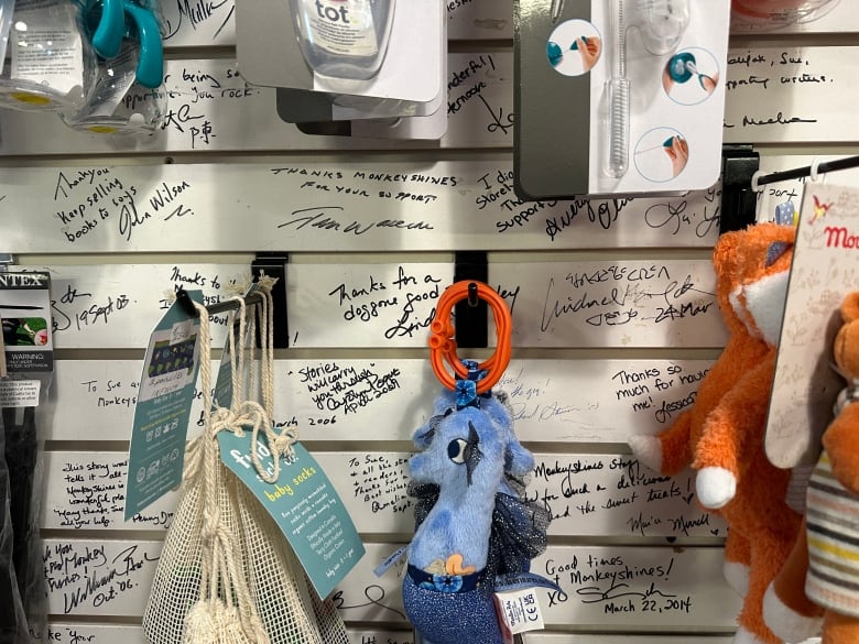 Close-up of thank-you messages on white, slat shelving.