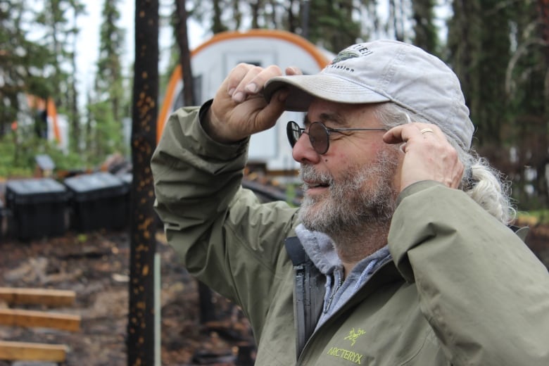 A man readjusting his hat.