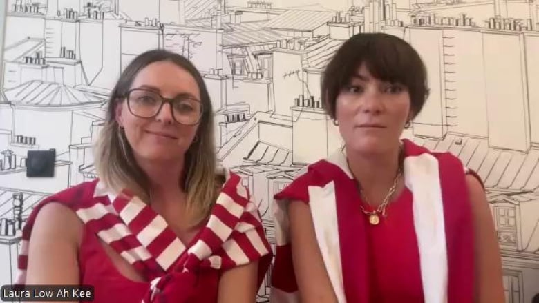 Two women dressed in white and red during a Zoom interview.