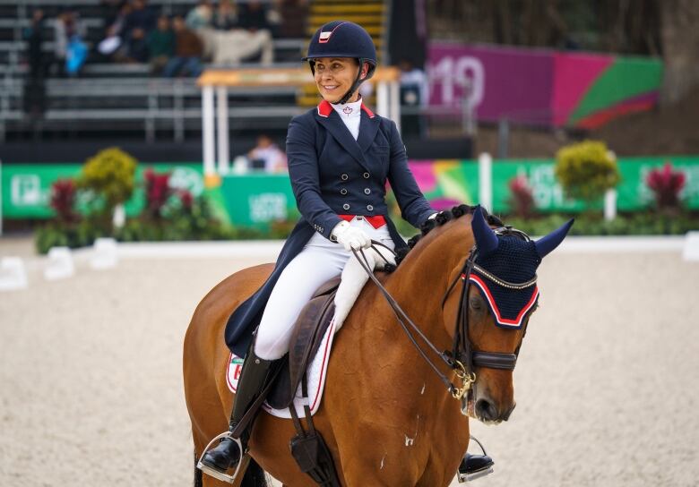 A woman riding on a horse in an equestrian event