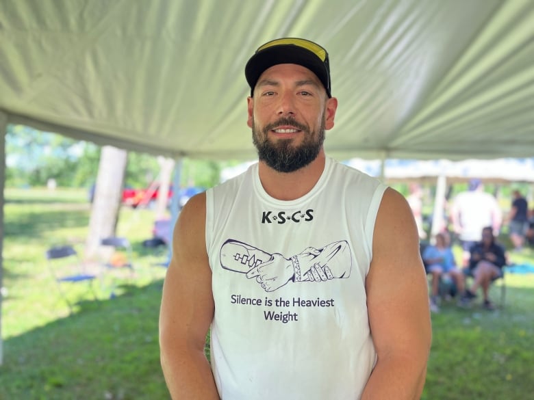 A man wearing a sleeveless t-shirt.