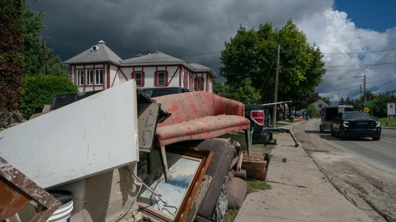 Trash thrown out on the curb following a flood. 