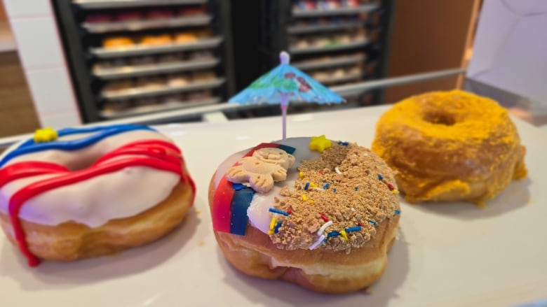 three donuts decorated for Acadian Day