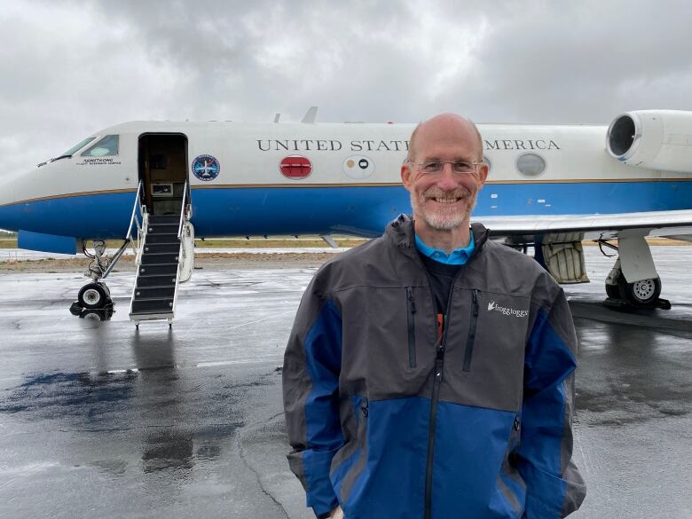 A man stands in front of a plane. Plane looks pretty average tbh but it is used for NASA research. 