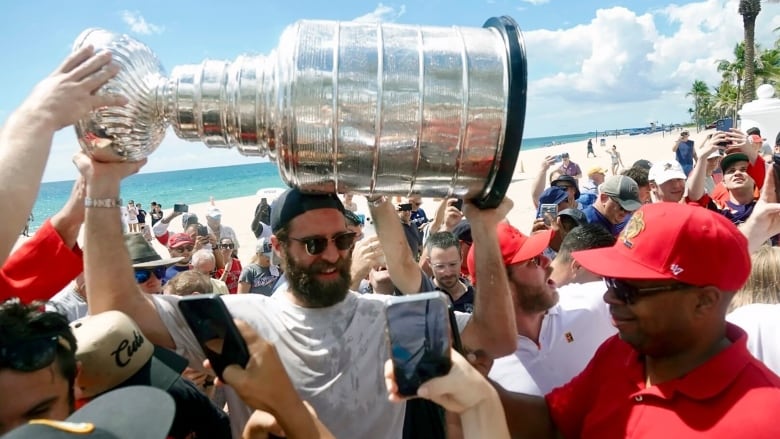 Florida Panthers NHL hockey player Aaron Ekblad carries the Stanley Cup in Fort Lauderdale, Fla., Tuesday, June 25, 2024. The Panthers beat the Edmonton Oilers 2-1 on Monday night in Game 7 of the Stanley Cup Final. (Joe Cavaretta/South Florida Sun-Sentinel via AP)