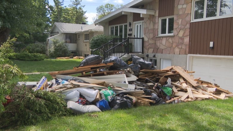 Lots of debris in front of a home in Laval.