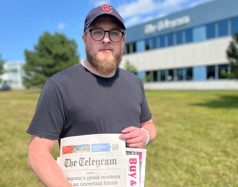 A man holds a newspaper