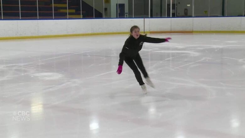 15 year old figure Skater Breanna Williams is mid-jump in an ice rink in Windsor.