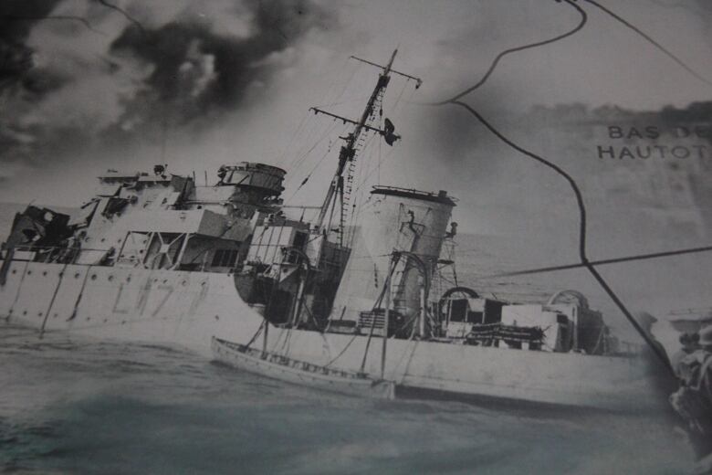 A historical image of a sinking WW2 Allied warship.