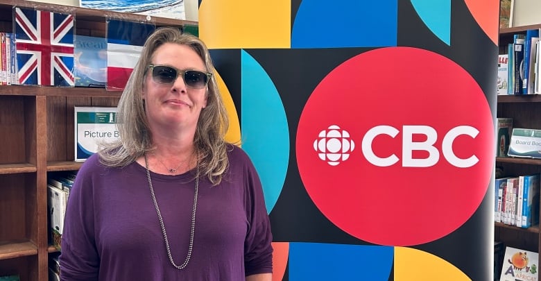 woman standing in front of CBC sign