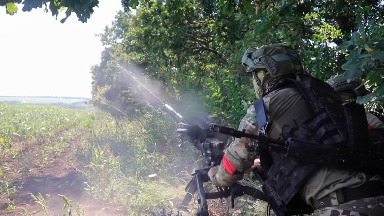 In this photo taken from video released by the Russian Defense Ministry on Monday, Aug. 19, 2024, Russian soldiers fire an AGS-17 automatic grenade launcher towards Ukrainian positions at an undisclosed location in the Russian-Ukrainian border area in the Kursk region of Russia.