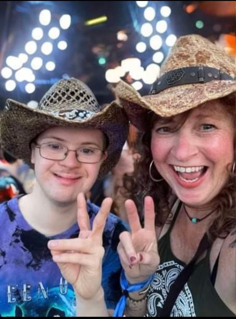 Two people wearing cowboy hats and smiling