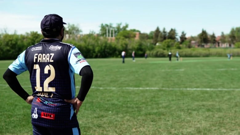 A player watches a men's cricket match in Regina.