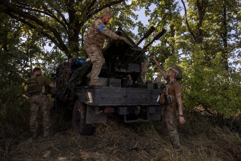 A soldier of Ukraine's 22nd Separate Mechanised Brigade covers up a ZU-23-2 anti-aircraft cannon during an exercise in the Sumy region near the Russian border, amid Russia's attack on Ukraine, August 17, 2024. 