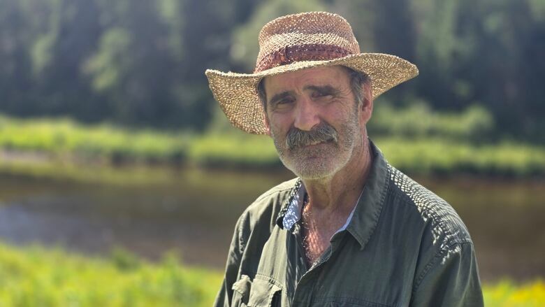 James Mills standing in front of Salmon River.