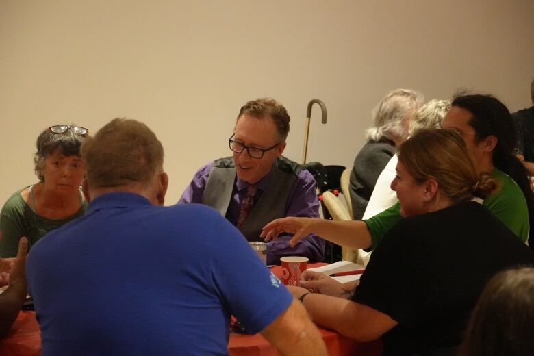 Peter Duck talks to a table of people