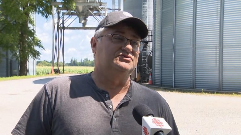 Man on a farm speaking into camera