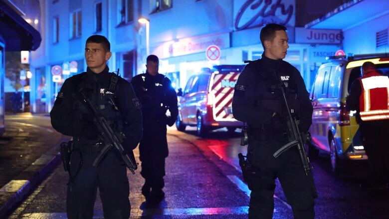 Police officers are seen near the scene of a deadly attack that occurred at a festival in Solingen, Germany, on Friday.