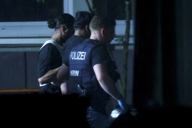 Police officers detain a person.