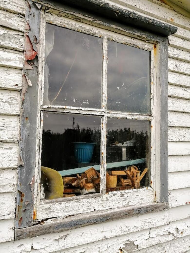 An old window, paint flaking away.